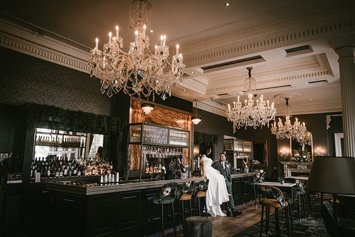 Bride sat on the bar at Oulton Hall