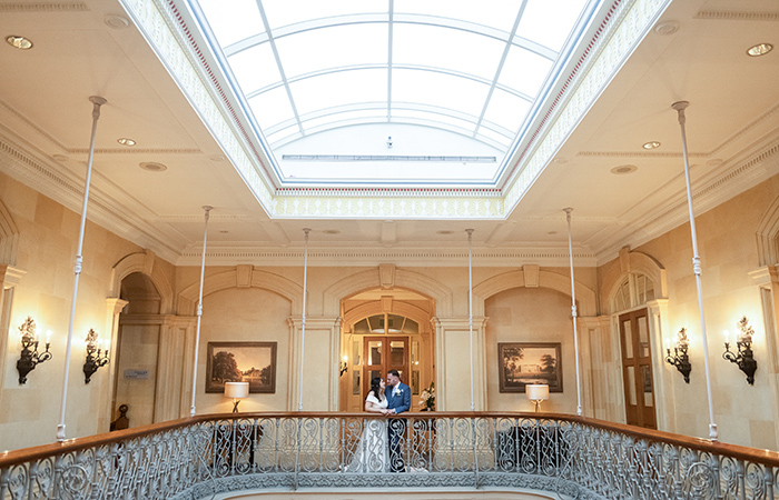 Bride and groom on the balcony at Oulton Hall