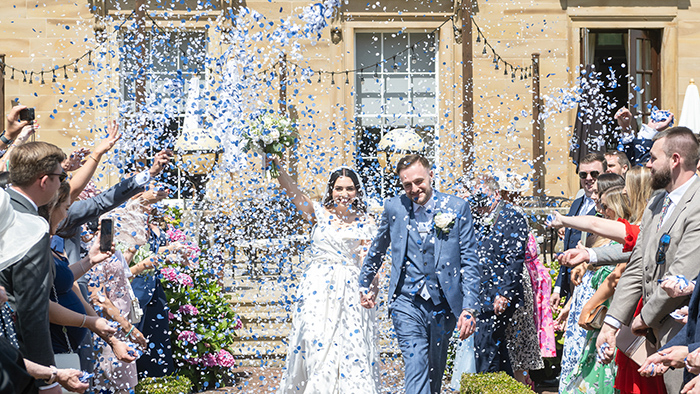 Confetti moment outside Oulton Hall with natural, candid photography.