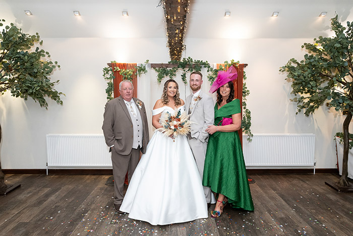 Family group photo taken inside Tankersley Manor on the wedding day.