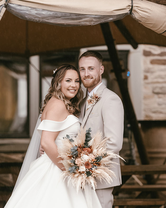 Bride and groom together under the tipi at Tankersley Manor due to rain.