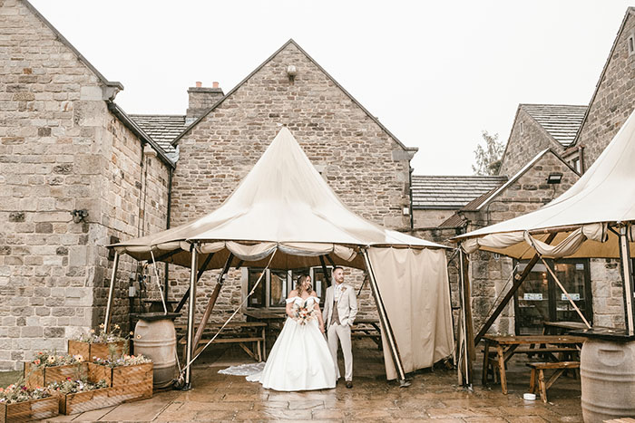 Bride and groom together under the tipi at Tankersley Manor due to rain.