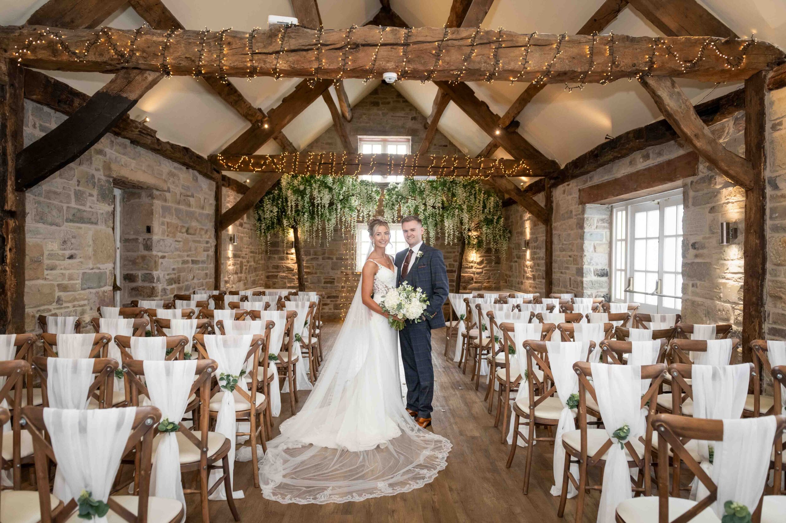 bride and groom stood in the rustic crook barn at tankersley manor