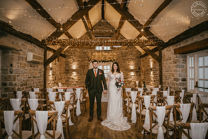 bride and groom in the rustic wedding barn at Tankersley Manor