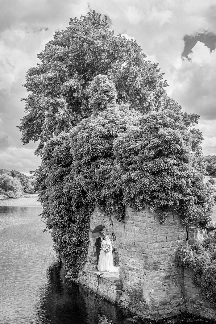 Bride and groom at Waterton Park Hotel on the bridge to Walton Hall