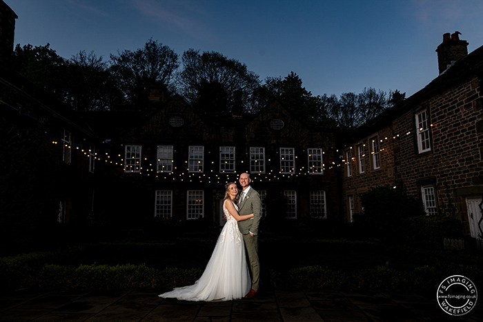 Bride and groom at night in the gardens at Whitley Hall