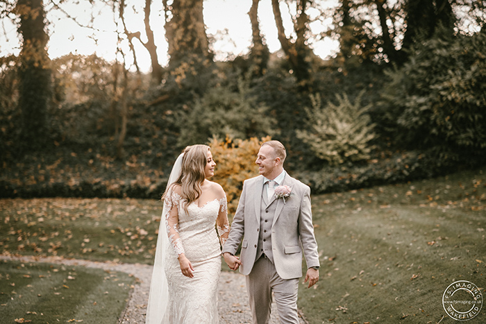 bride and groom walking in the grounds of The Woodlands Hotel in Leeds