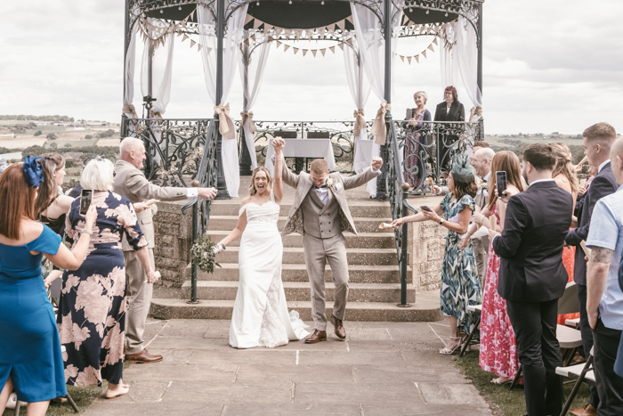 bride and groom walking up the aisle at Cubley Hall