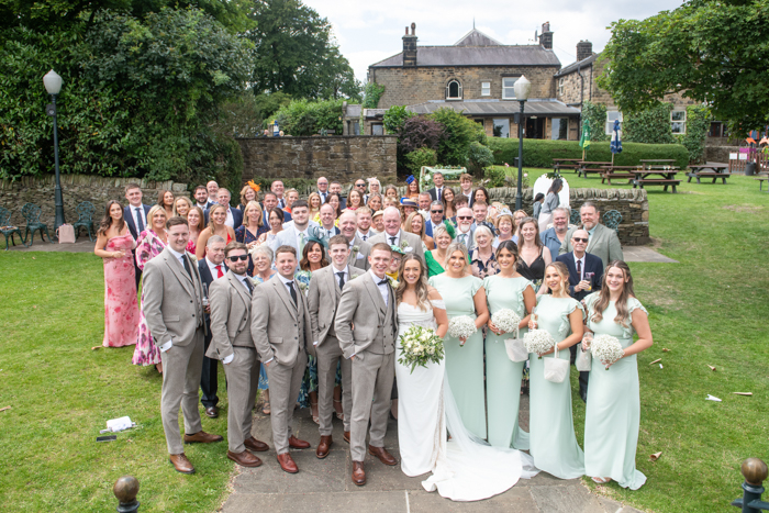 Full wedding party group photo on the lawn at Cubley Hall
