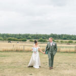 bride and groom walking in the fields at Inkersall Grange Farm