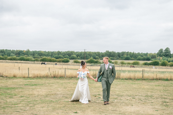 bride and groom walking in the fields at Inkersall Grange Farm