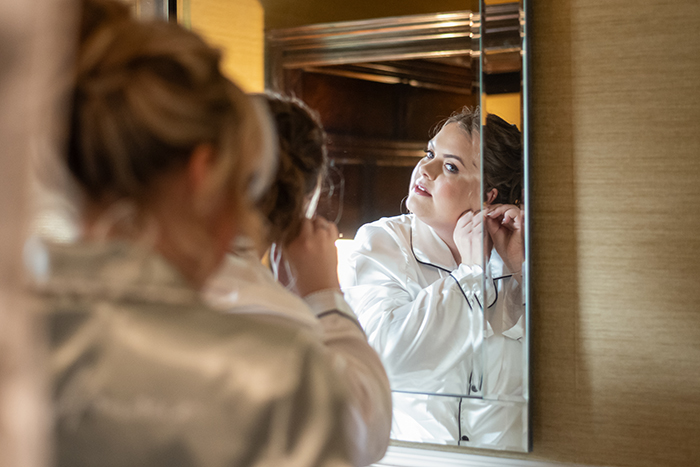 Bride having her makeup done during morning preparations at Whitley Hall