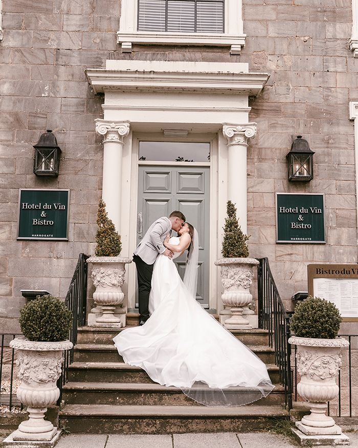bride and groom on the stairs outside hotel du vin harrogate