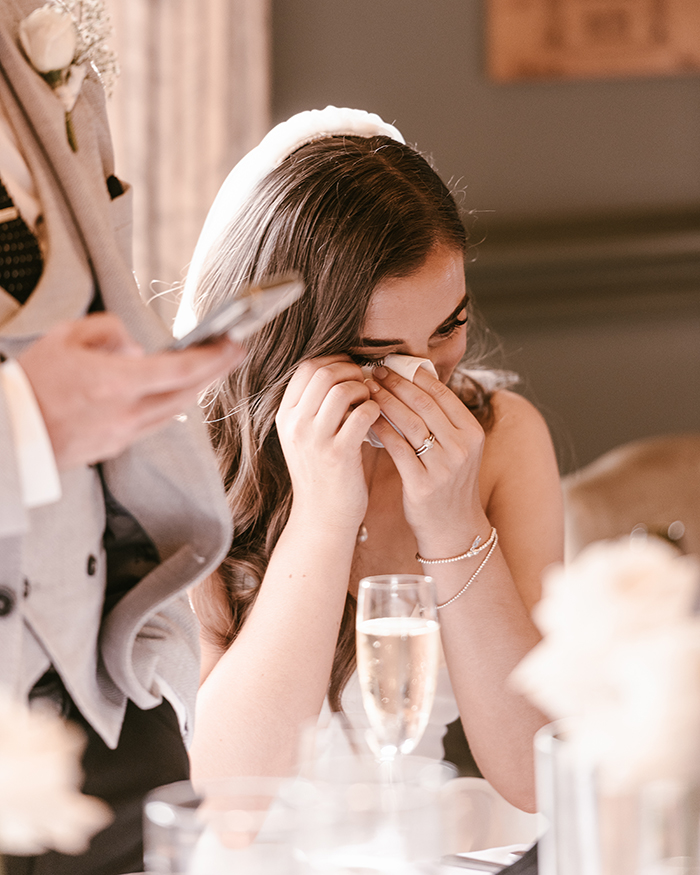 bride wiping a tear from her eye on speeches at hotel du vin harrogate