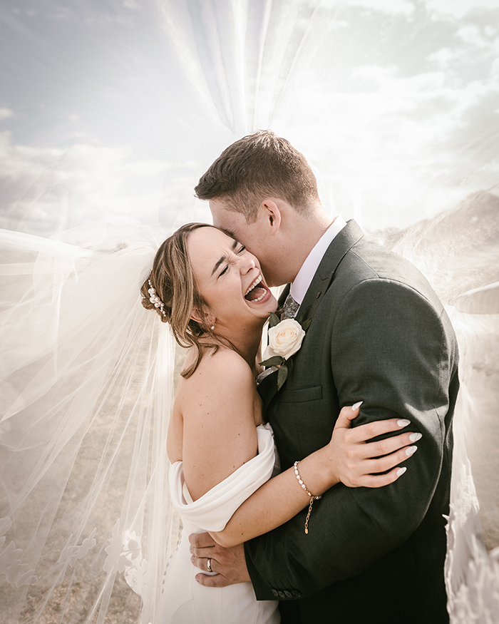 bride and groom laughing under a veil at Woodstock Weddings York